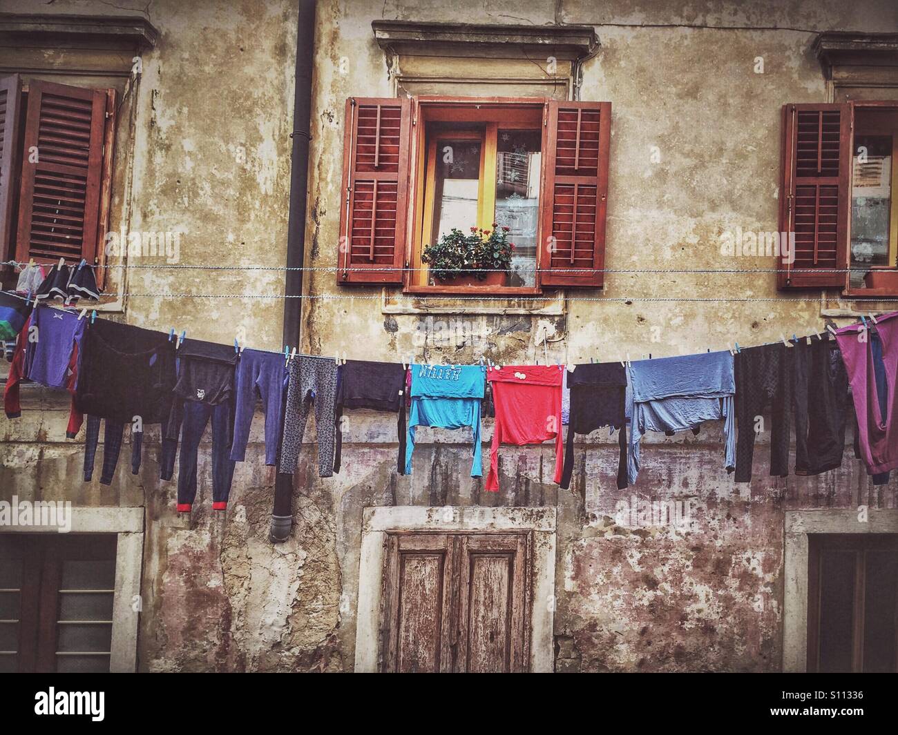 Laundry drying in front of the old house - Smartphone Captured Stock Image