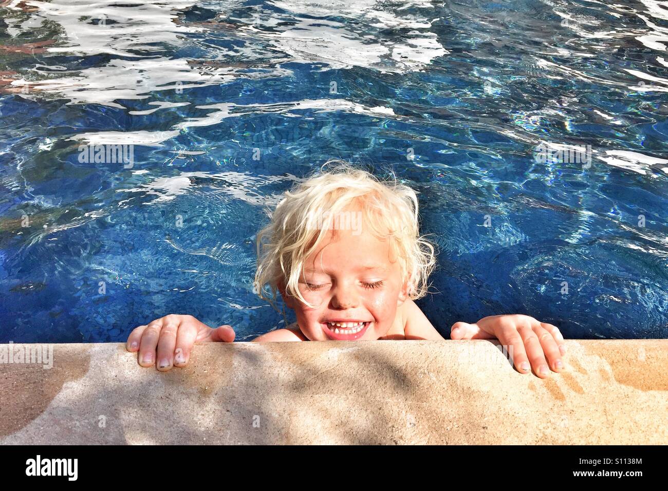 Happy boy in the pool Stock Photo