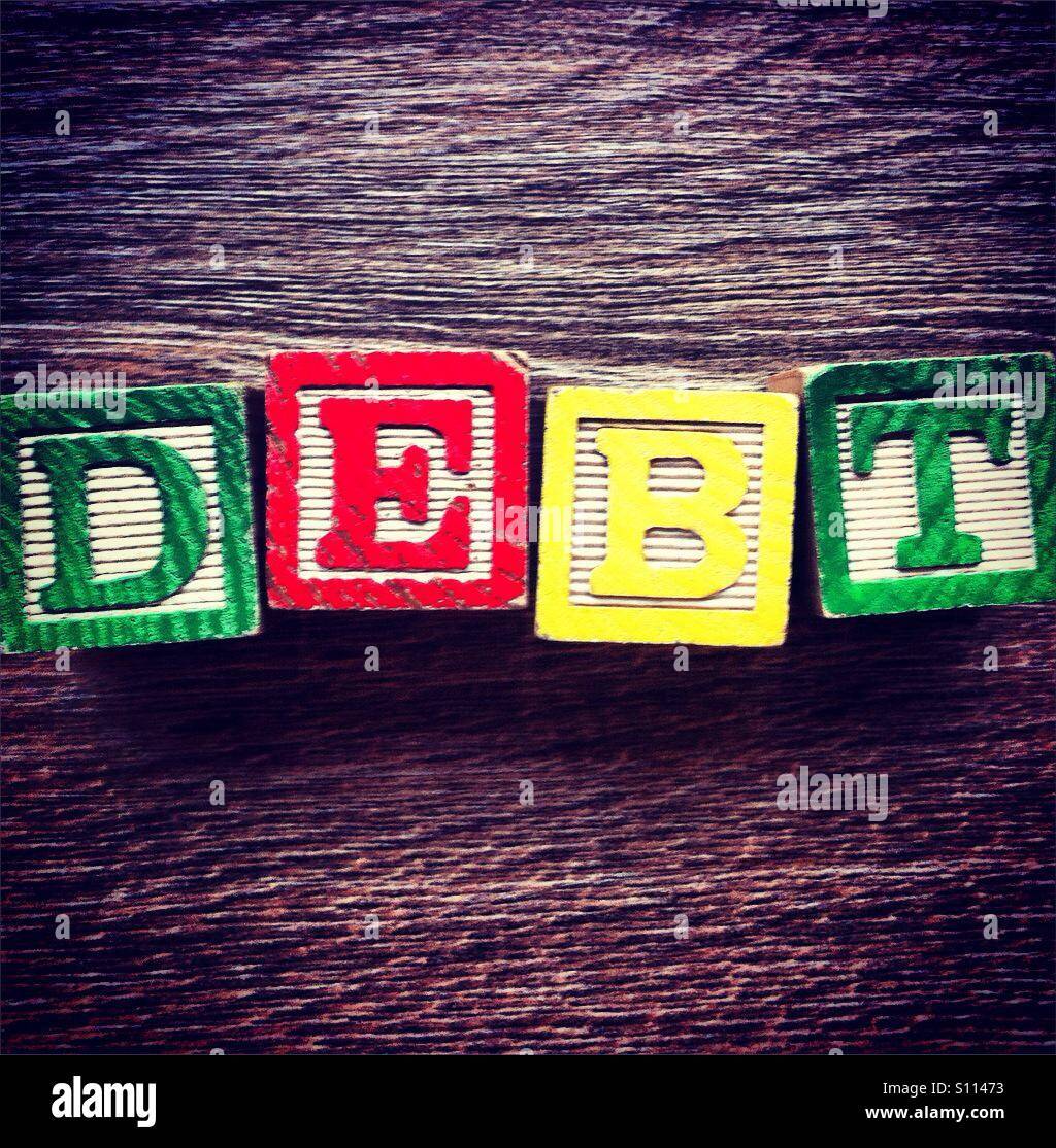 Word DEBT done with wood blocks letters Stock Photo Alamy
