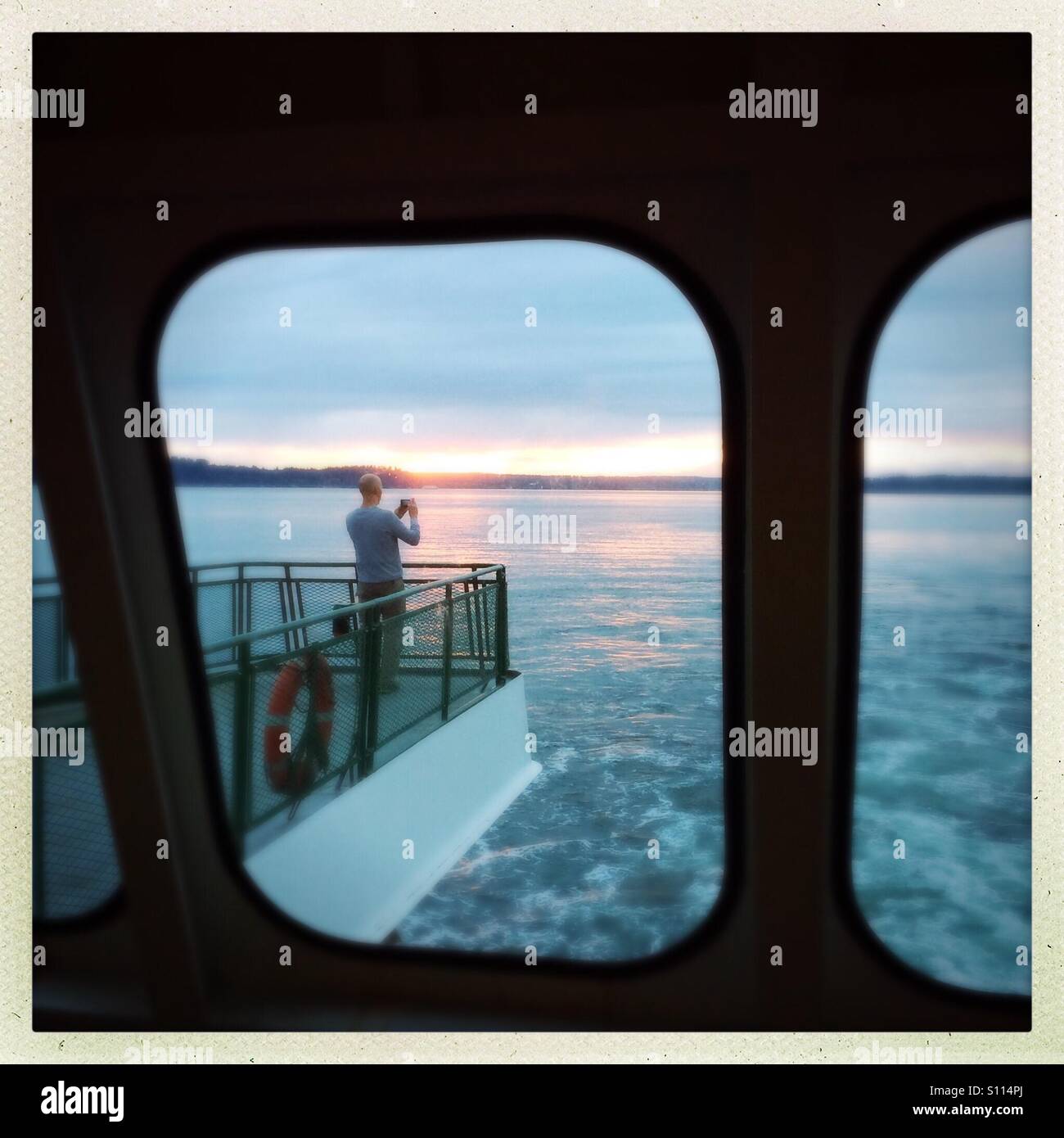 Photographing sunset from bow of Washington State Ferry. Puget Sound, Washington - Smartphone Captured Stock Image