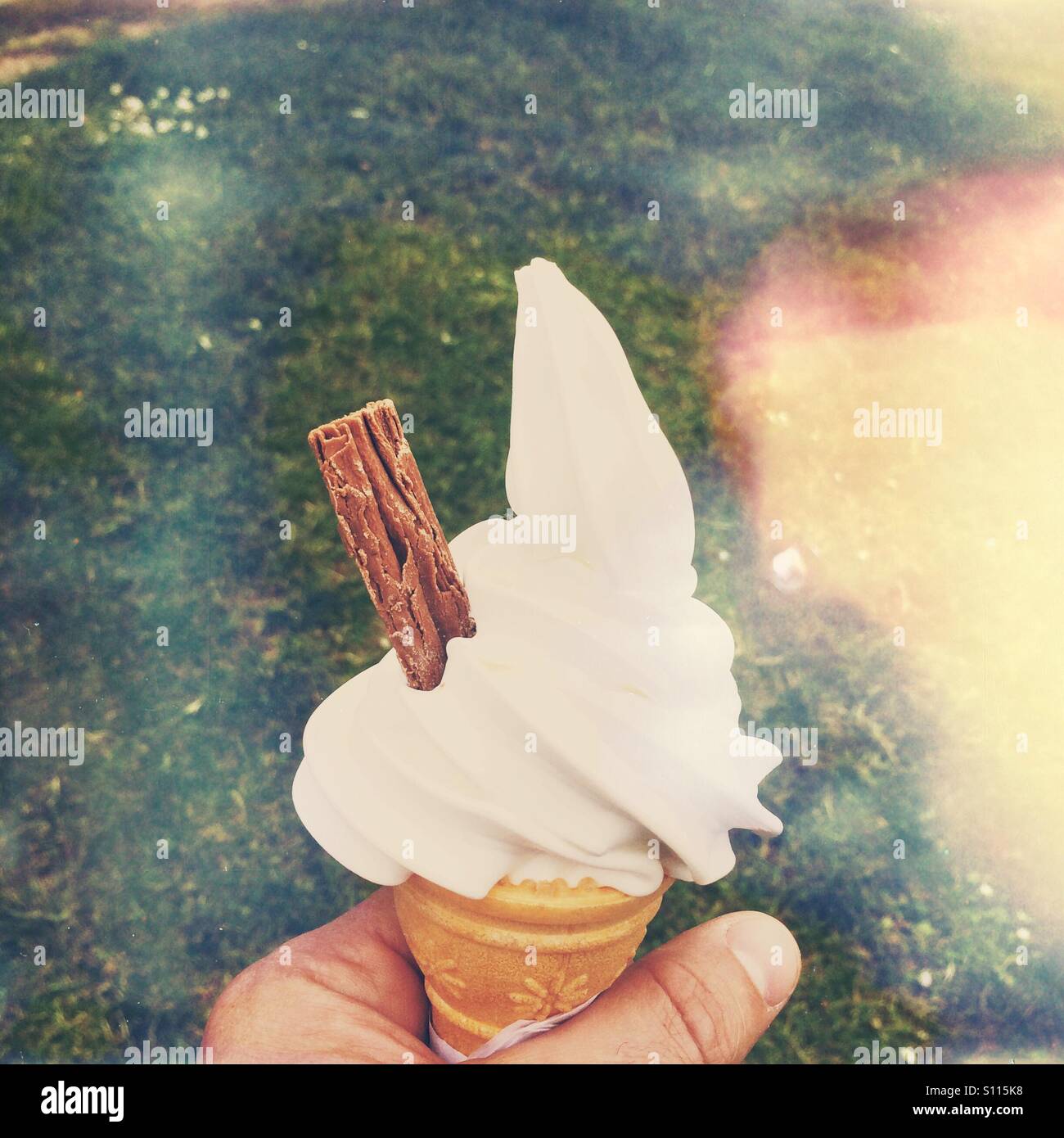 Male hand holding an ice cream '99' cone - Smartphone Captured Stock Image Male hand holding an ice cream '99' cone - Smartphone Captured Stock Image