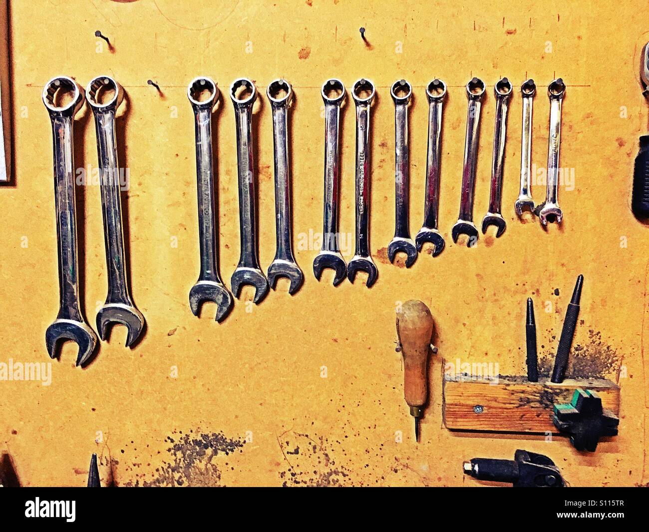 Spanners and work tools hanging on a wall - Smartphone Captured Stock Image