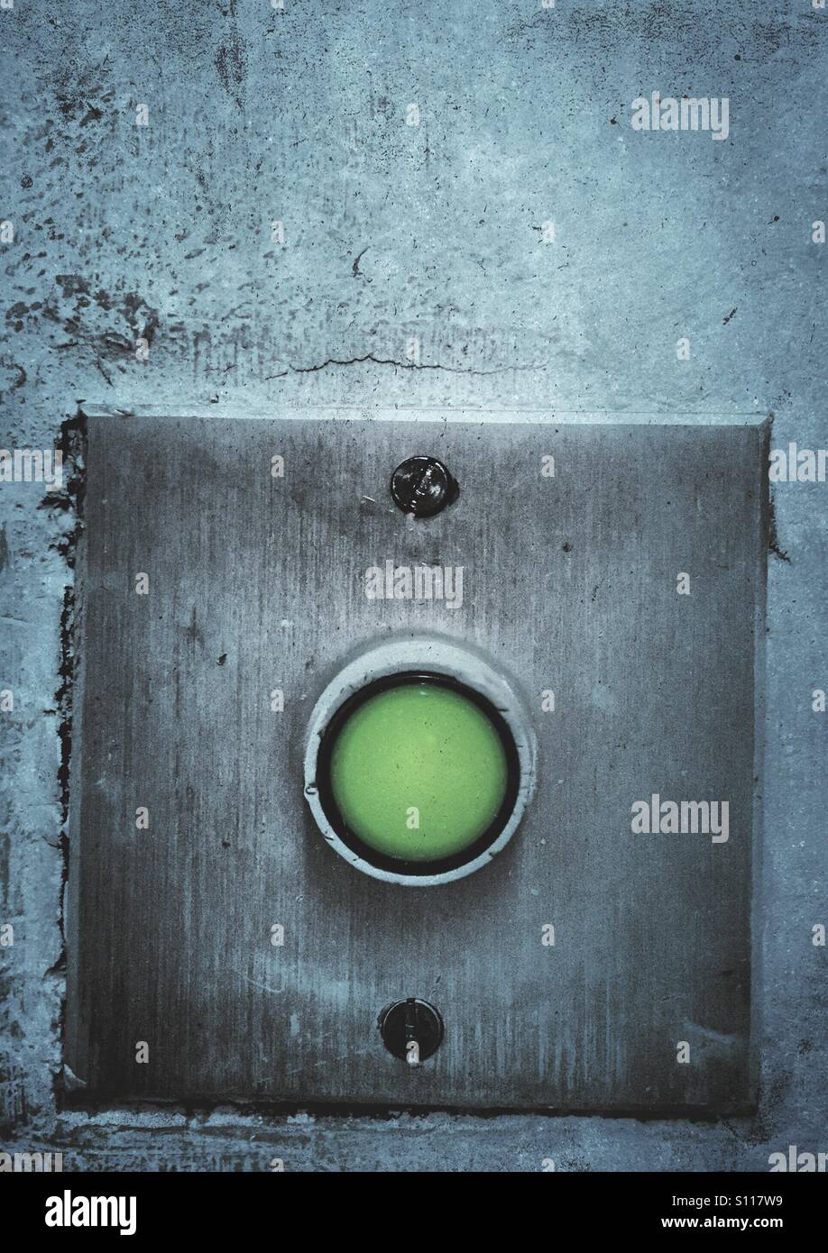Green button for exit door - Smartphone Captured Stock Image