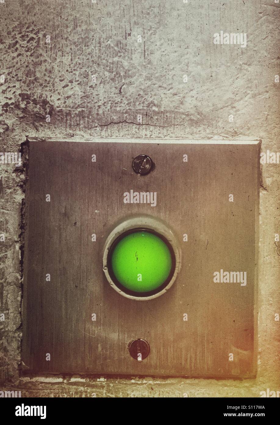 Green button for exit door - Smartphone Captured Stock Image