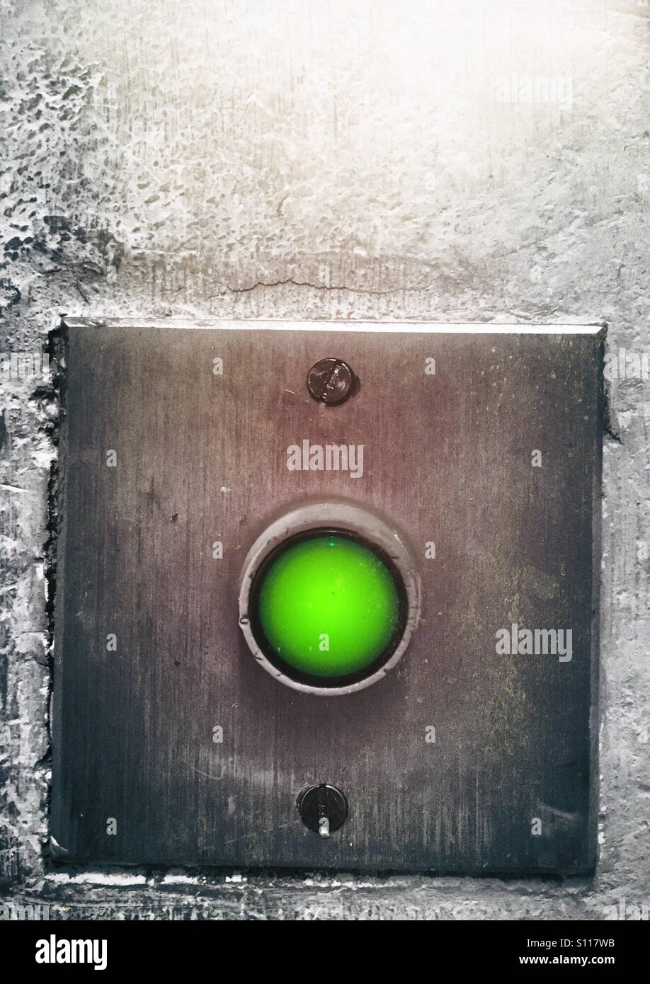 Green button for exit door - Smartphone Captured Stock Image