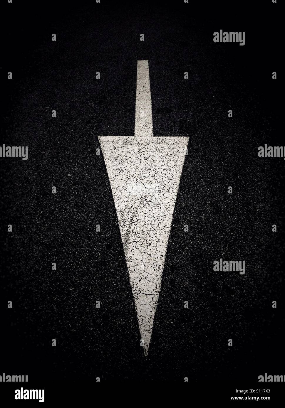White down arrow painted on road - Smartphone Captured Stock Image