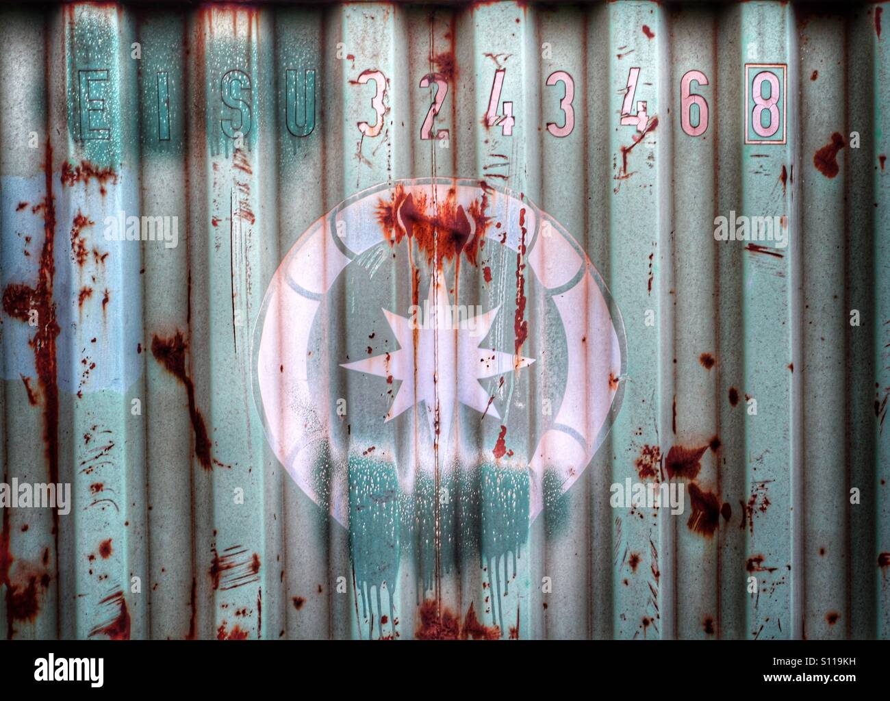 A mysterious symbol painted on the side of a metal container. - Smartphone Captured Stock Image