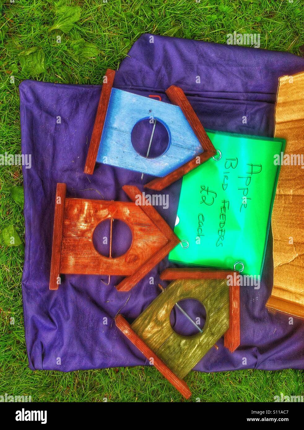 Bird feeders for sale at a summer fair. - Smartphone Captured Stock Image