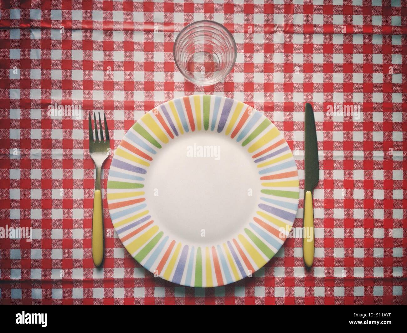 Flatware and squared tablecloth on a table before lunch Stock Photo