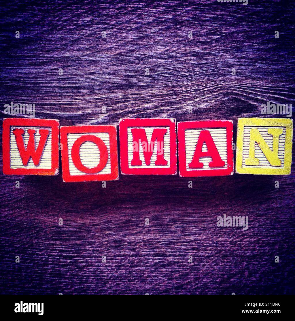 Word WOMAN done with alphabet wood blocks letters - Smartphone Captured Stock Image