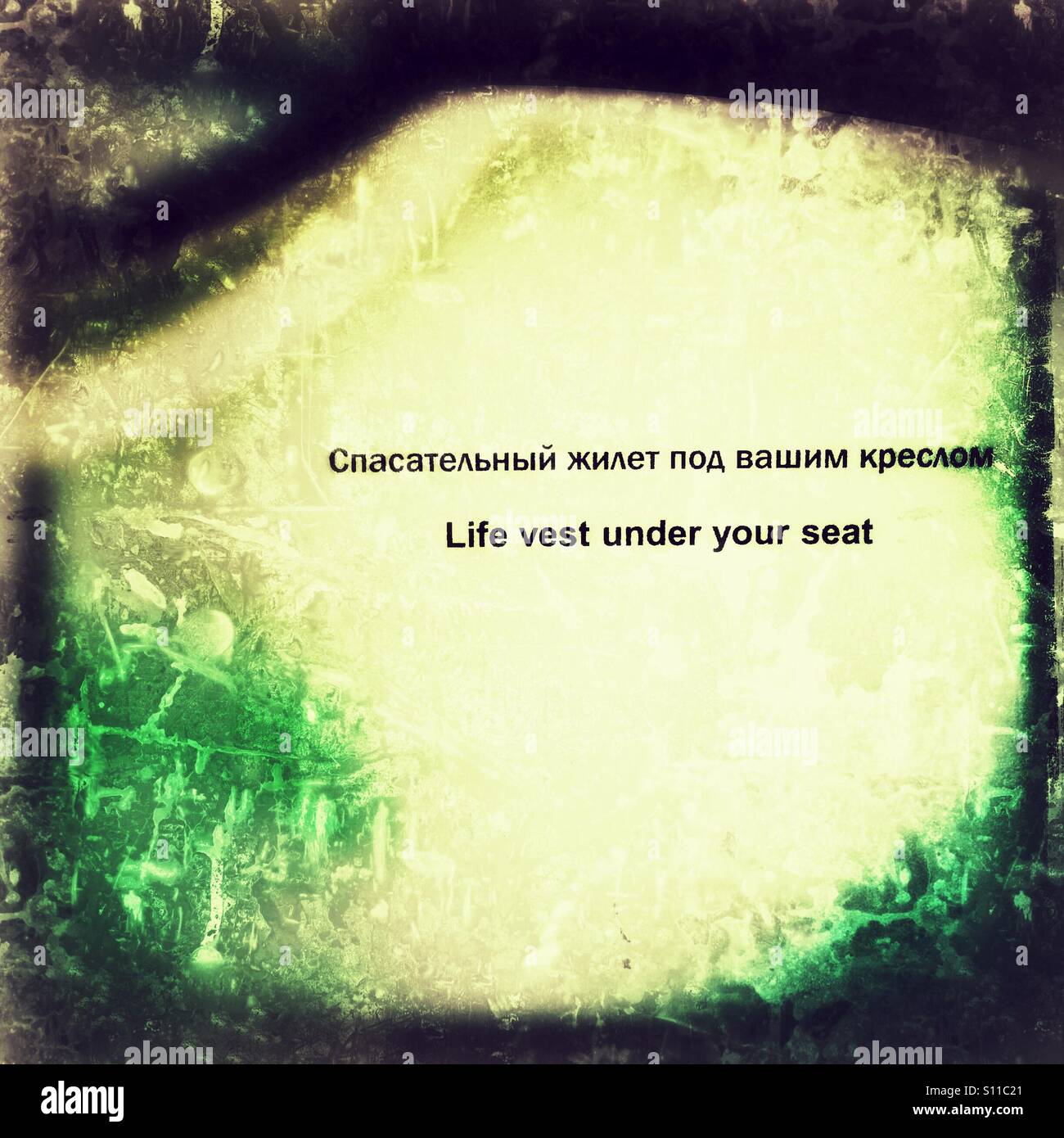 Life vest under your seat in English and Russian - Smartphone Captured Stock Image