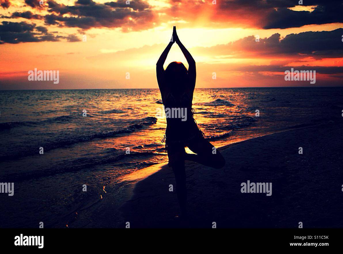 Yoga at sunset, Vrikshasana - Smartphone Captured Stock Image