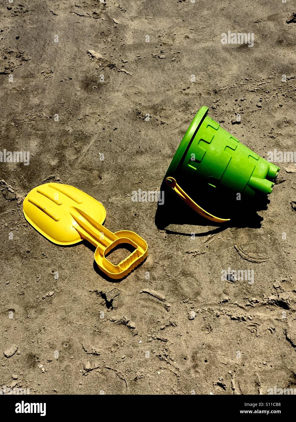 Shovel and sand bucket on beach Stock Photo