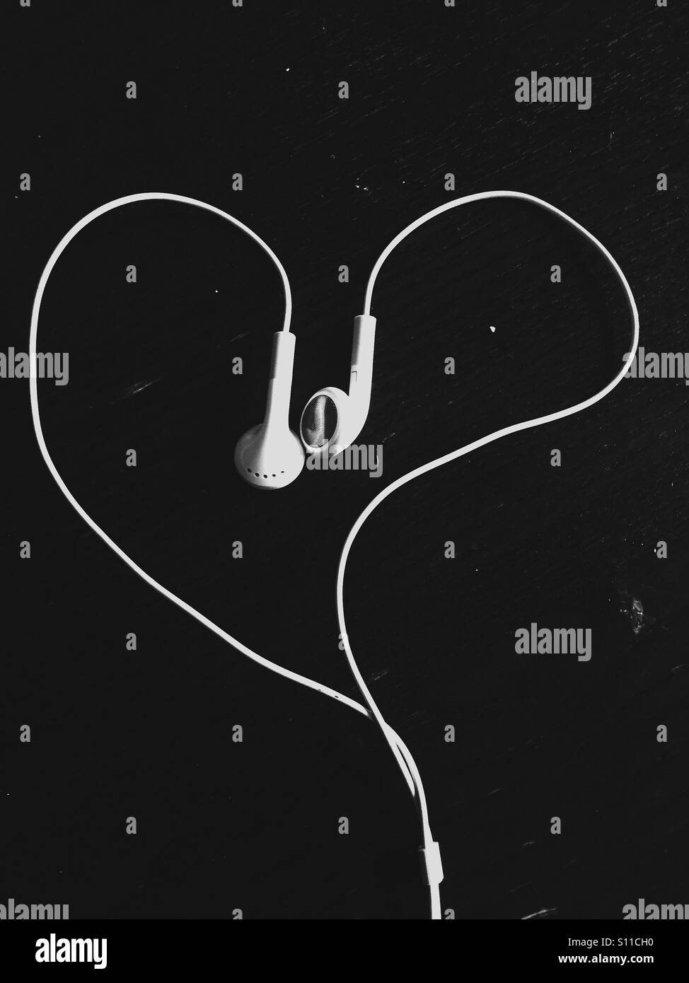 Headphones shaped as a heart. Stock Photo