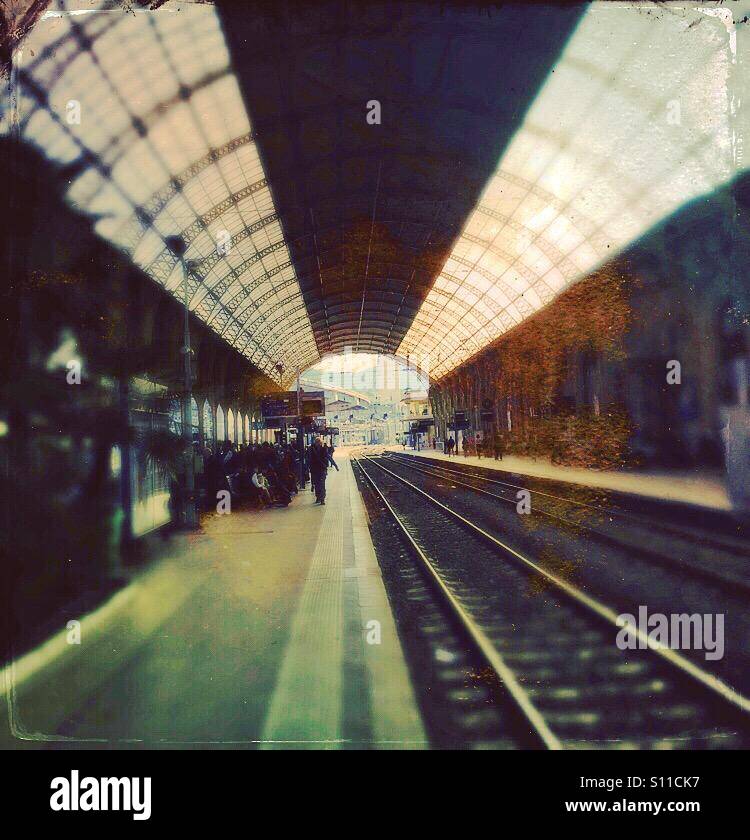 Train tracks leaving a European train station with skylights above - Smartphone Captured Stock Image