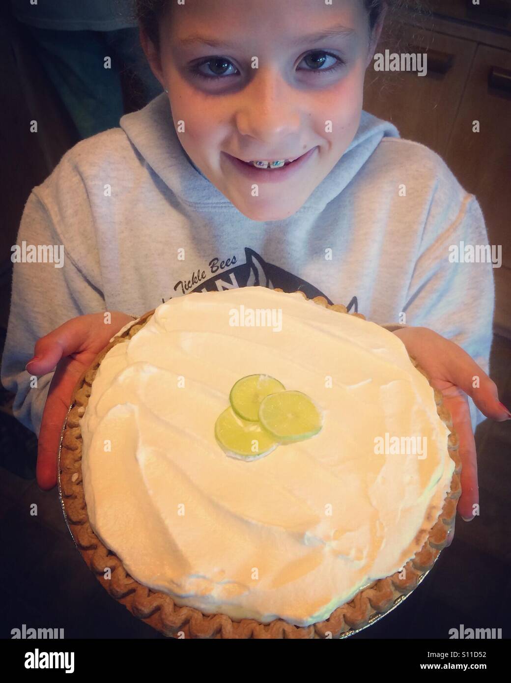 11-year old Maya and her homemade Key lime pie, Florida - Smartphone Captured Stock Image