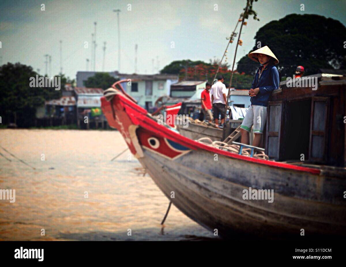Boat with man at Mekong delta Stock Photo - Alamy