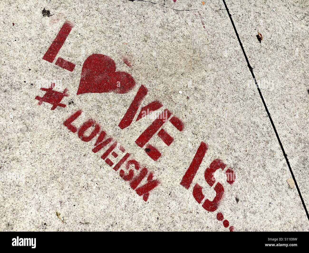 'Love is' sidewalk art in Wynwood Miami Stock Photo