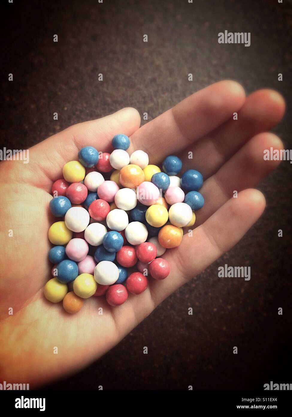 Glazed candies in hand Stock Photo