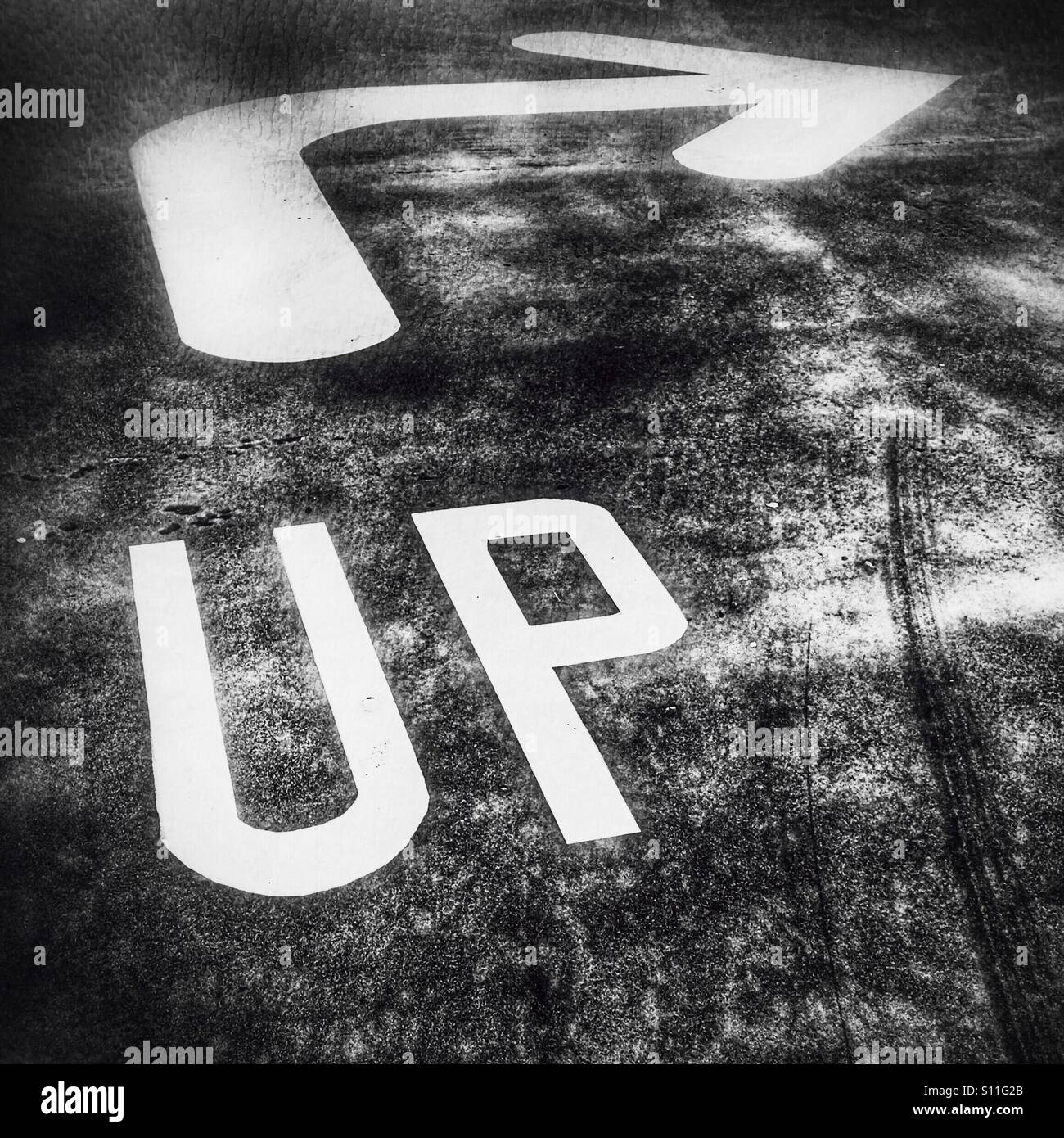 Abstract black and white image of an upward arrow and direction marking, symbolising business growth, leadership, strategic direction and progress. - Smartphone Captured Stock Image