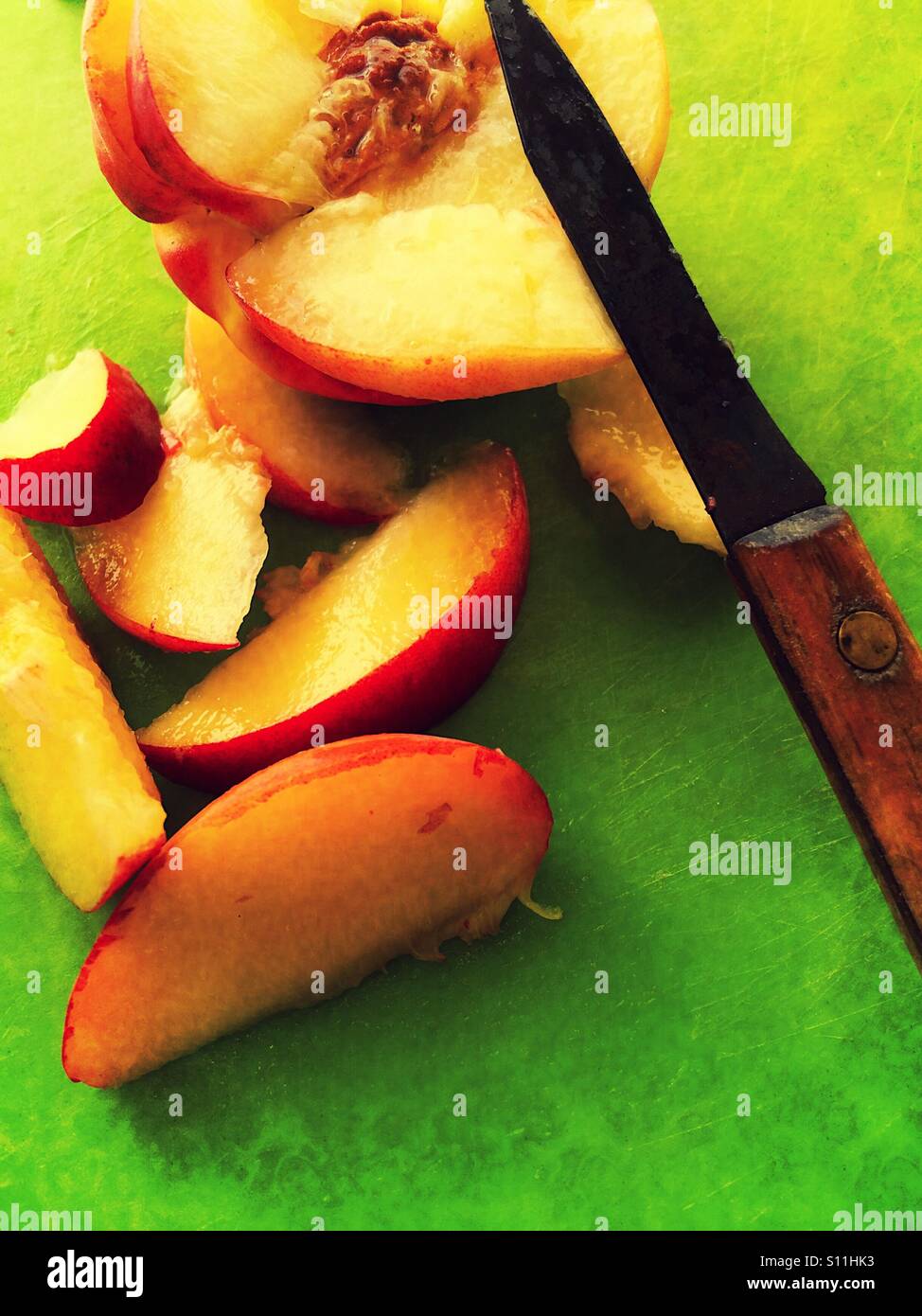 Slicing a fresh peach - Smartphone Captured Stock Image
