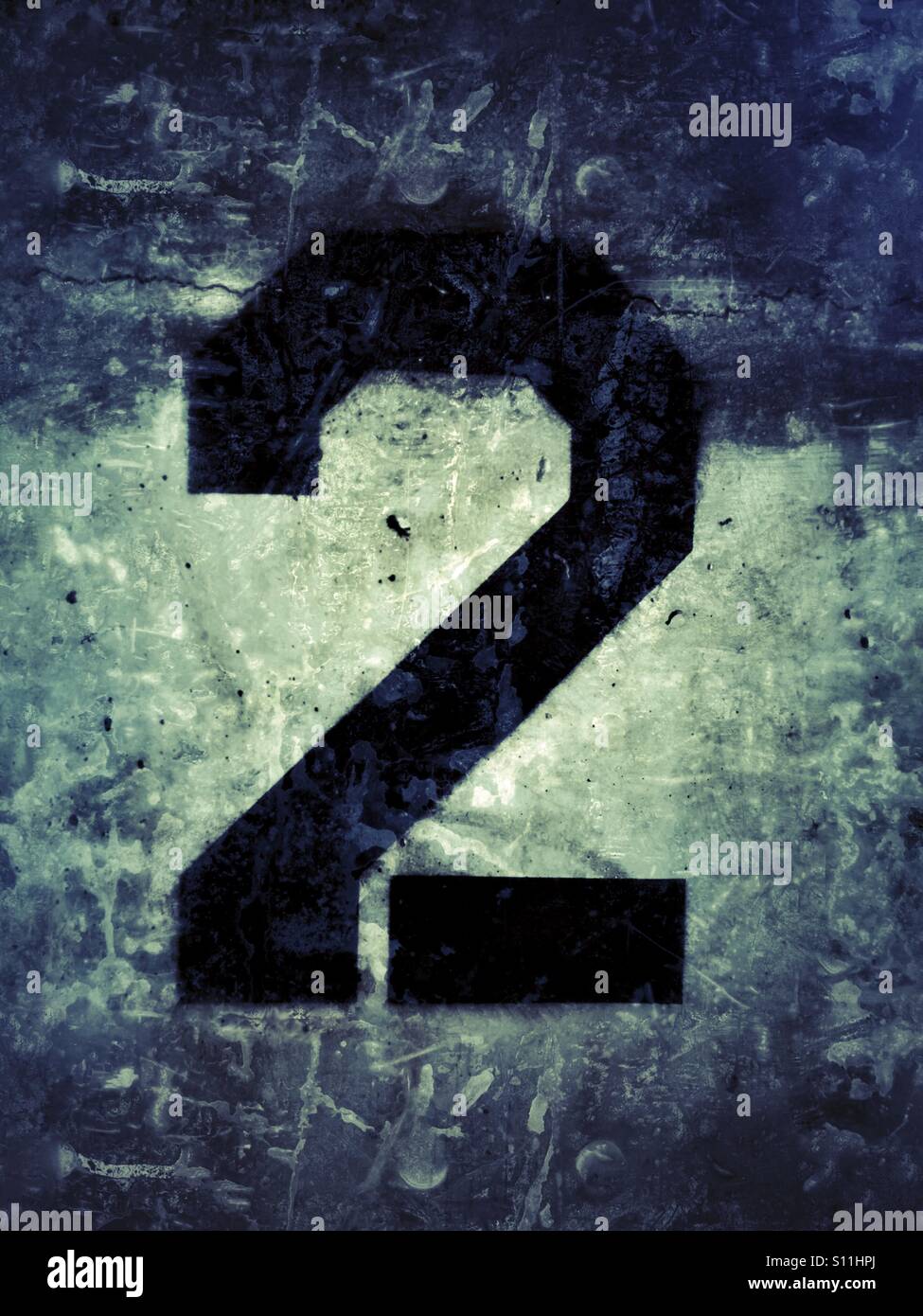 Number two stenciled in black on wall - Smartphone Captured Stock Image