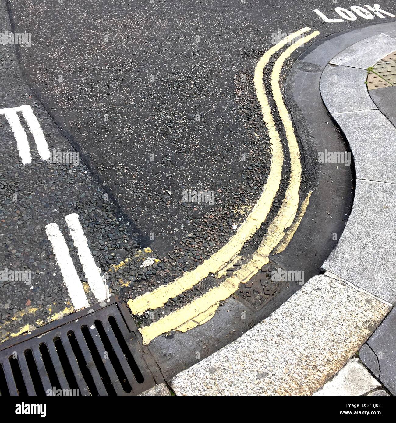Road signs and yellow parking lines in London - Smartphone Captured Stock Image