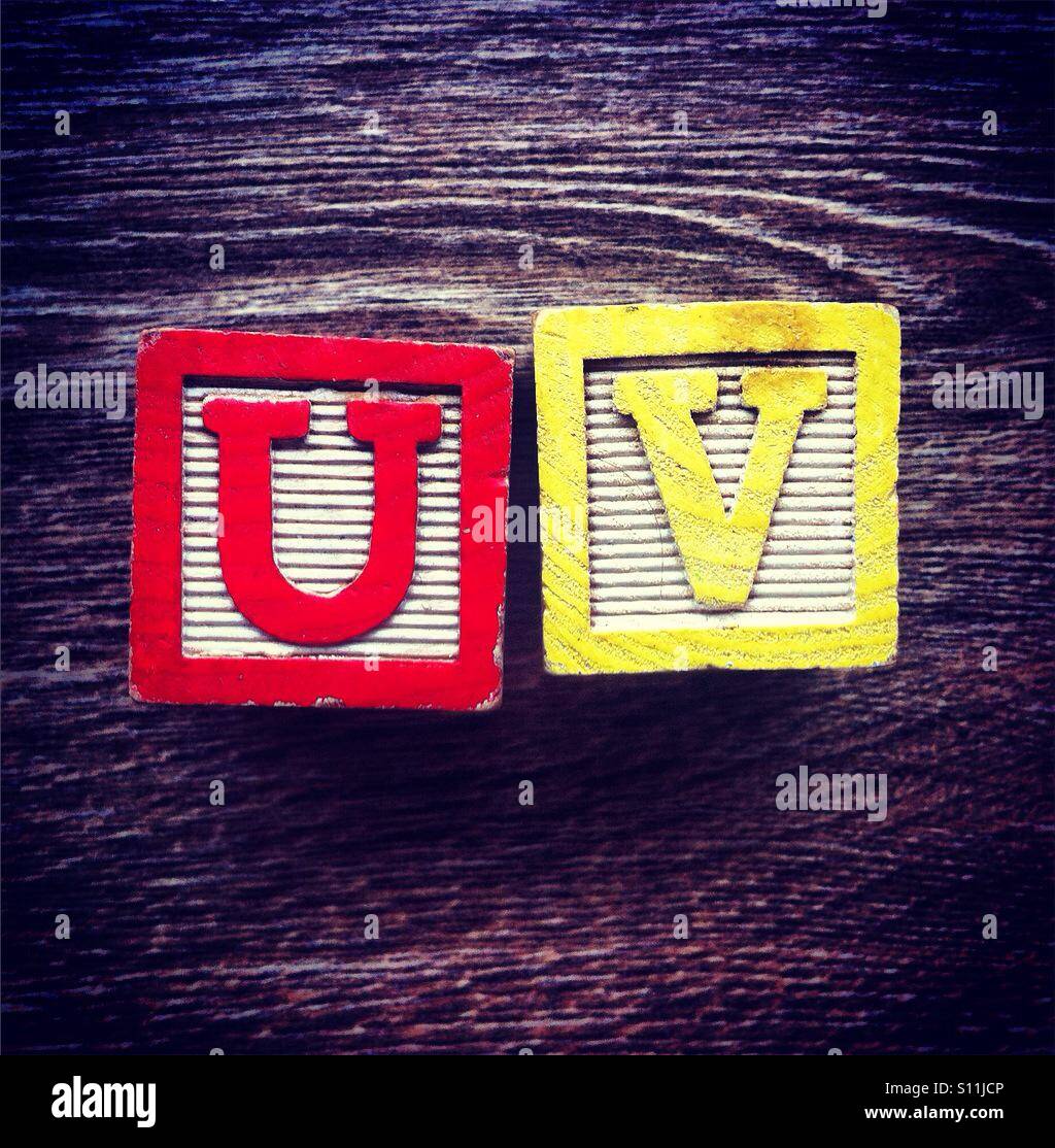 Acronym UV for Ultra Violet done with alphabet wood block letters Stock Photo