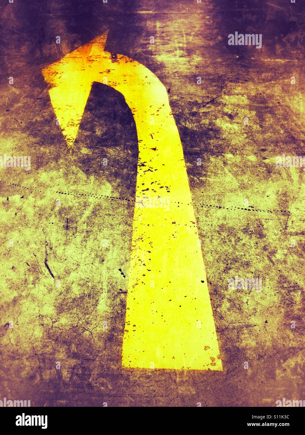 Big yellow arrow painted on a concrete path - Smartphone Captured Stock Image