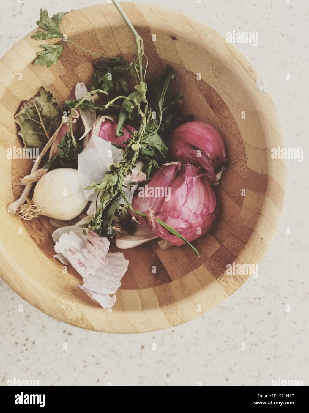 Garlic with herbs in rustic wooden bowl top view Stock Photo