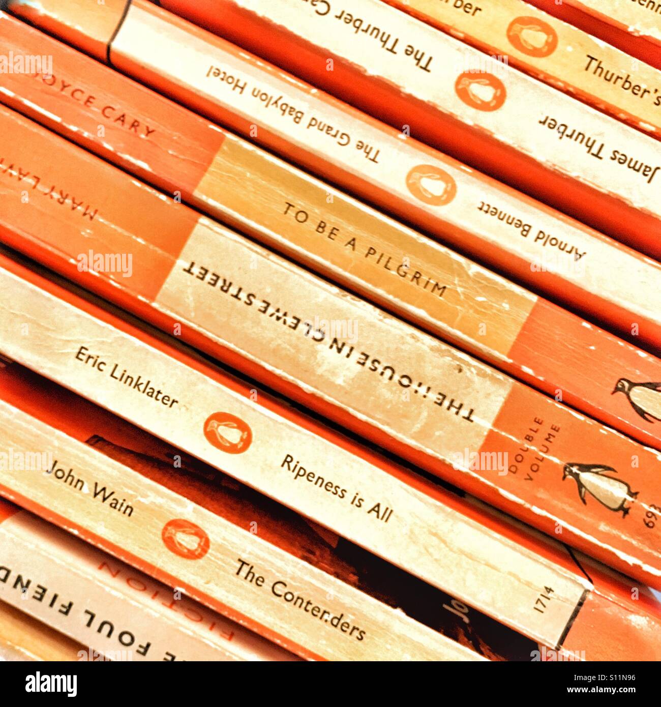 Pile of orange paperback books Stock Photo
