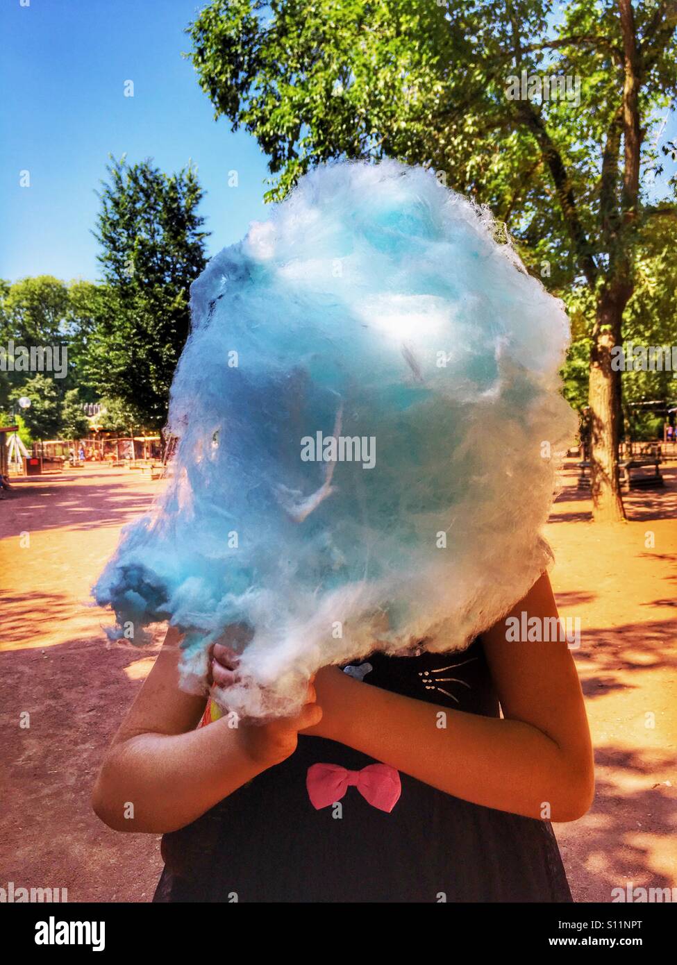 Little girl with blue fairy floss. Stock Photo