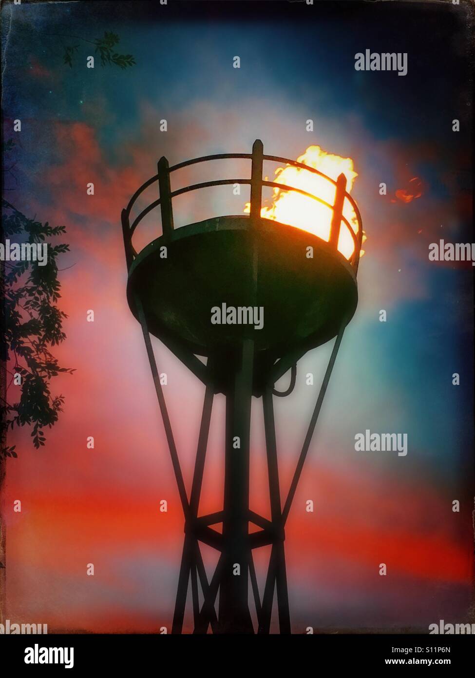 Torch burning against colorful sunset - Smartphone Captured Stock Image