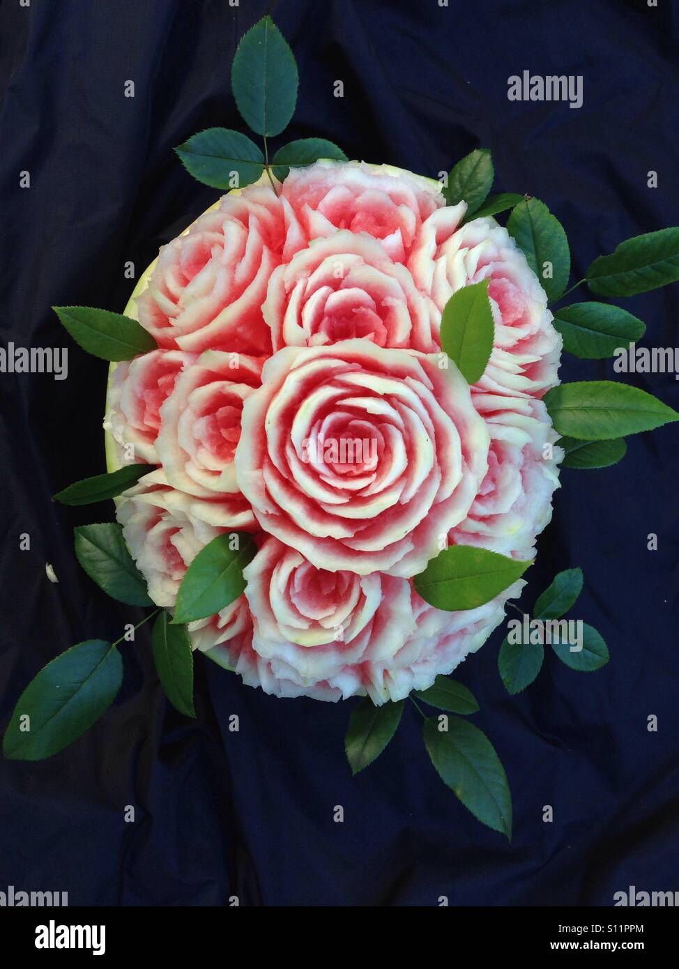 Fruit carving of roses using a watermelon Stock Photo