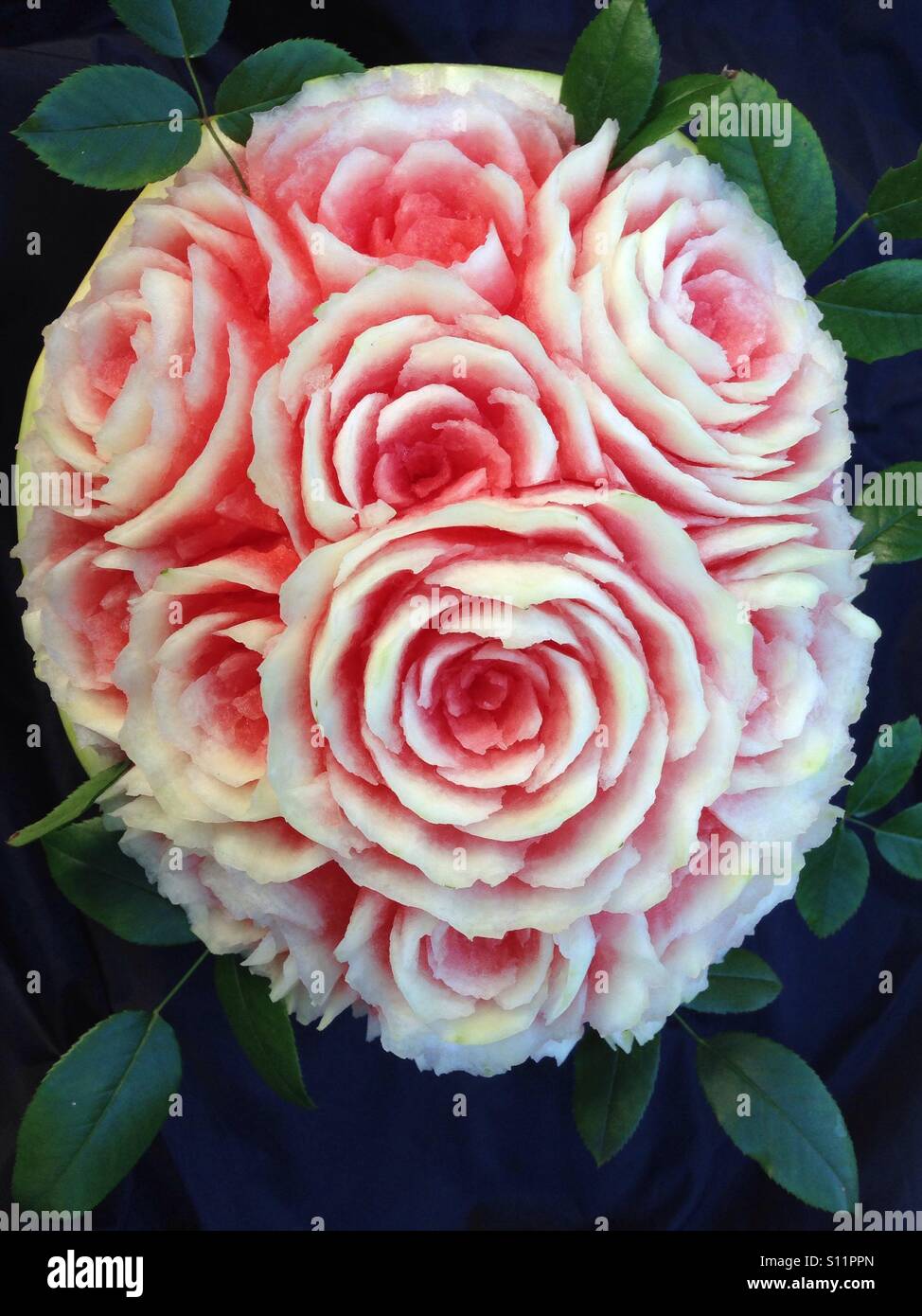 Fruit carving of roses using a watermelon Stock Photo