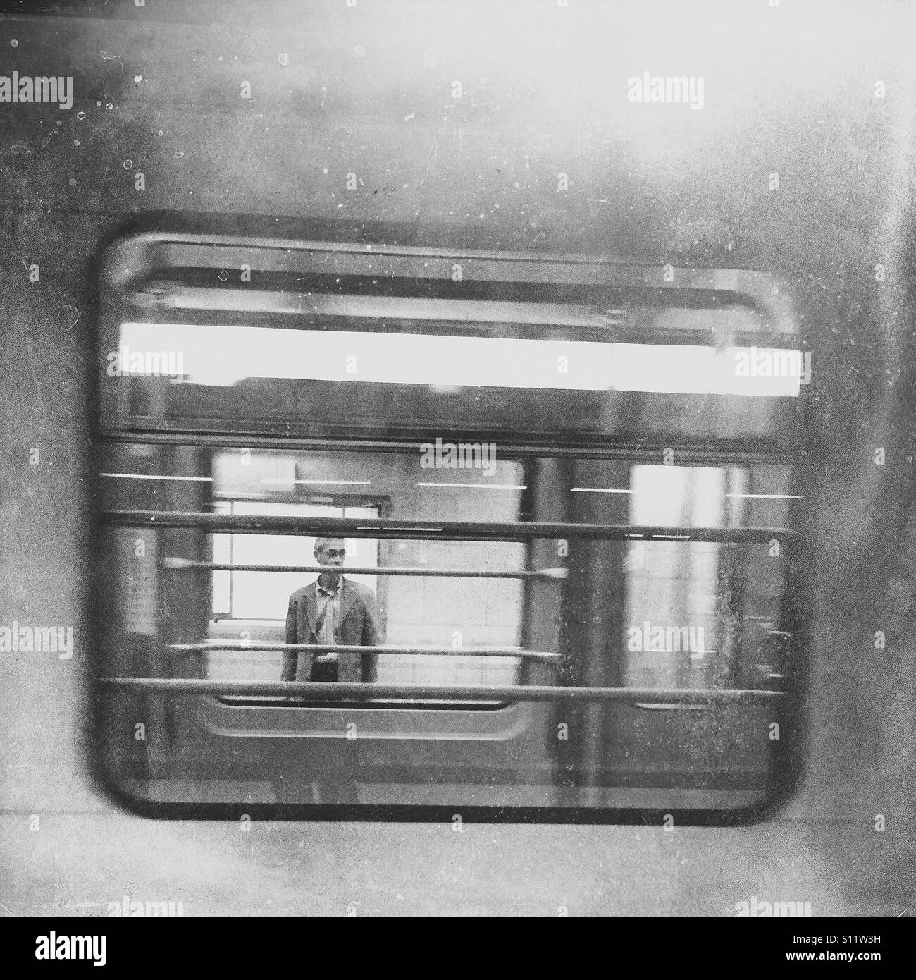 Window into the soul. Man seen through the windows of a subway car. - Smartphone Captured Stock Image