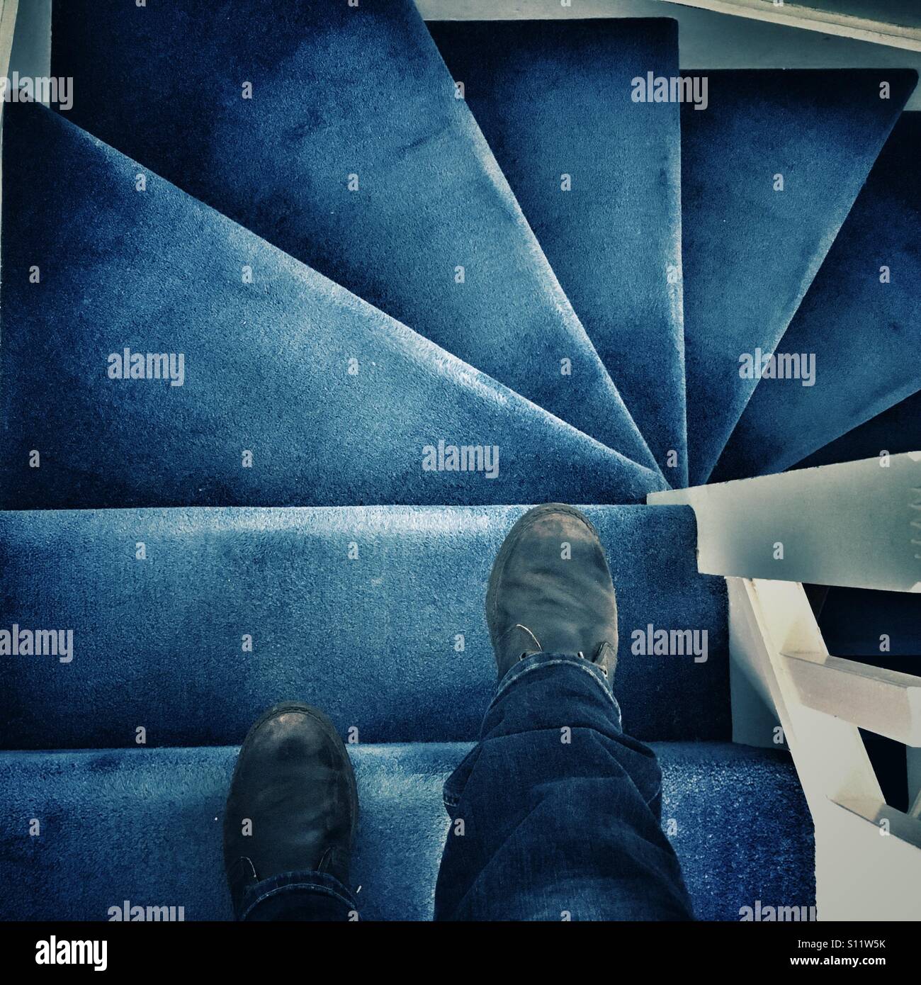 POV. Walking down a blue carpeted staircase. - Smartphone Captured Stock Image