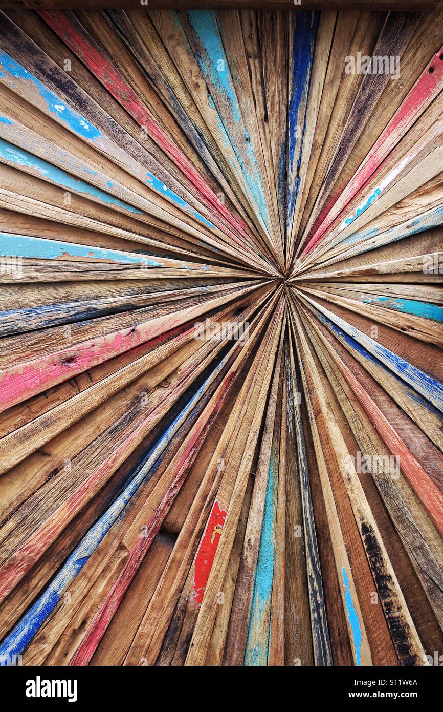 A colourful and abstract wooden background with lines converging off centre. Stock Photo