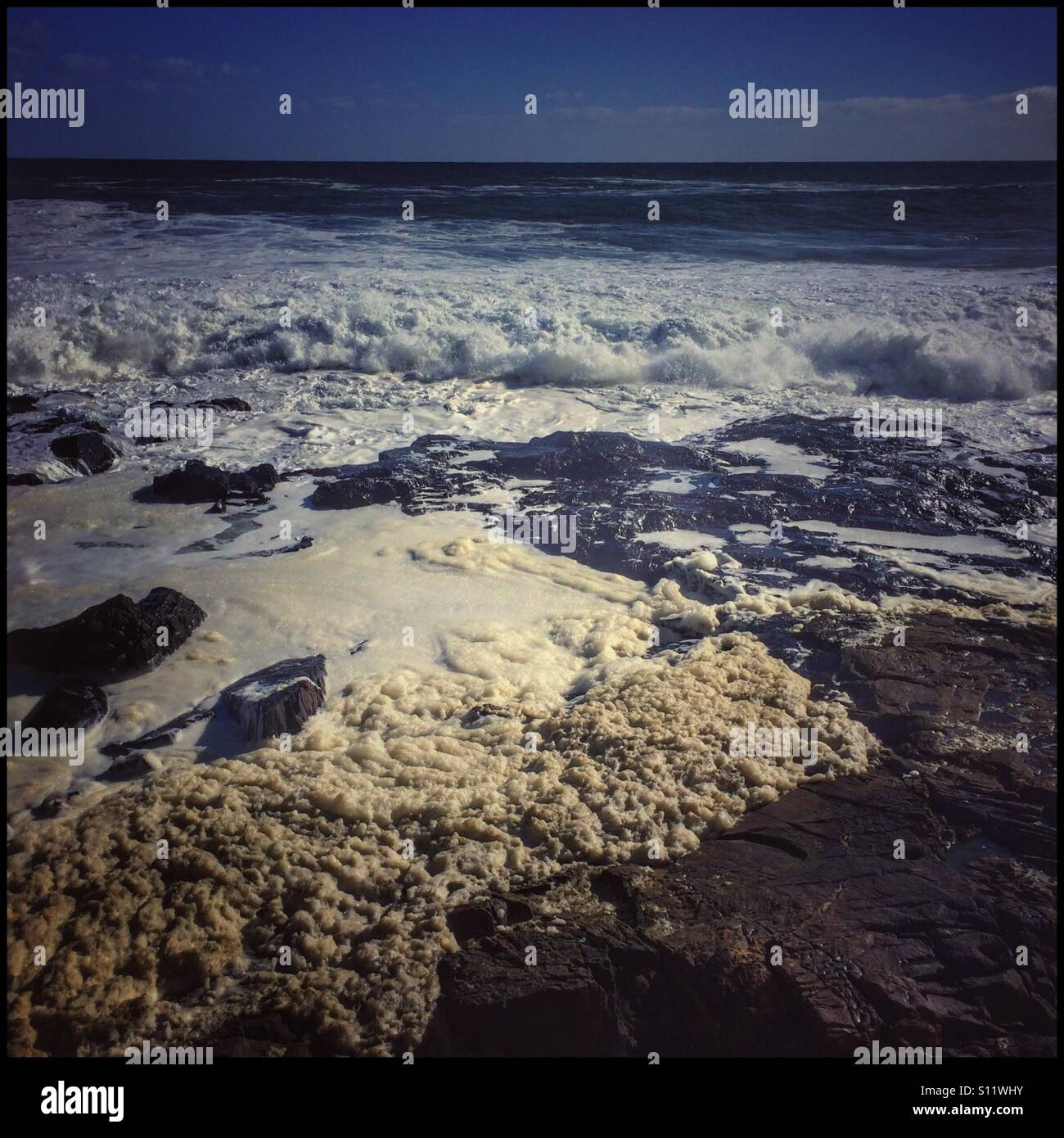 Waves breaking along Seapoint shoreline. - Smartphone Captured Stock Image