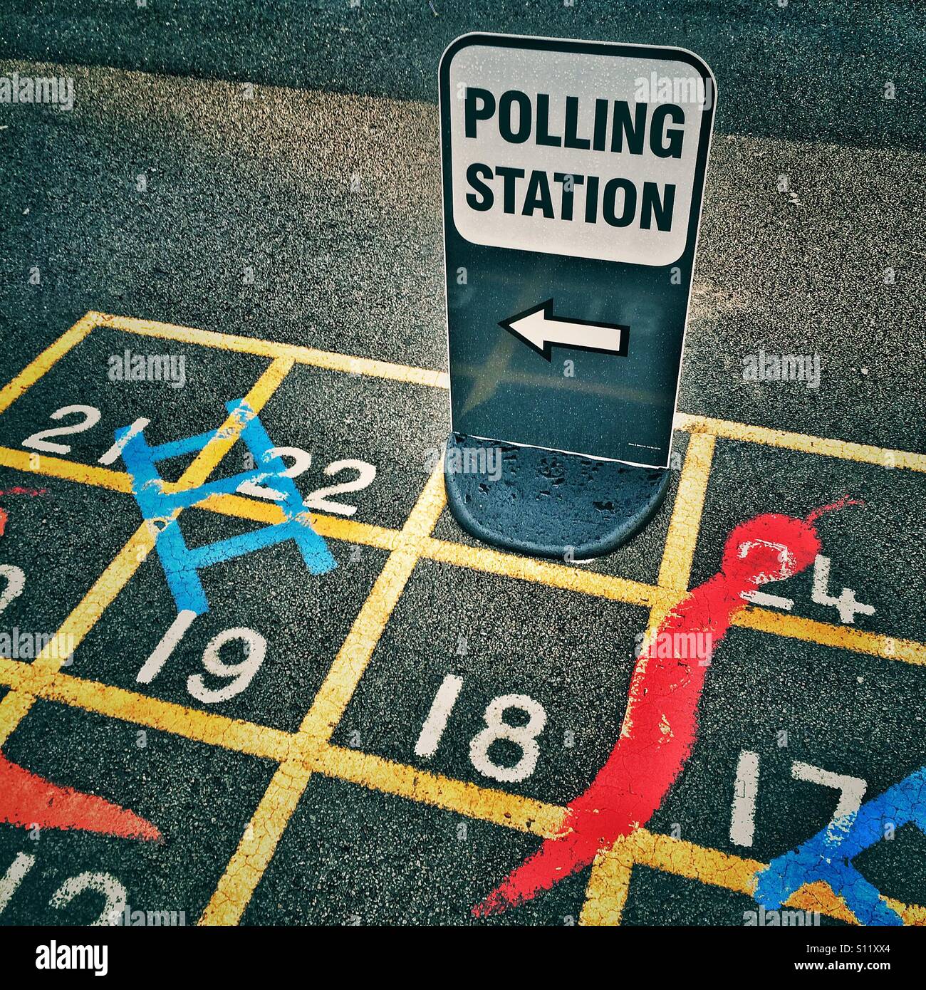 A polling station sign on a snakes and ladders board - Smartphone Captured Stock Image