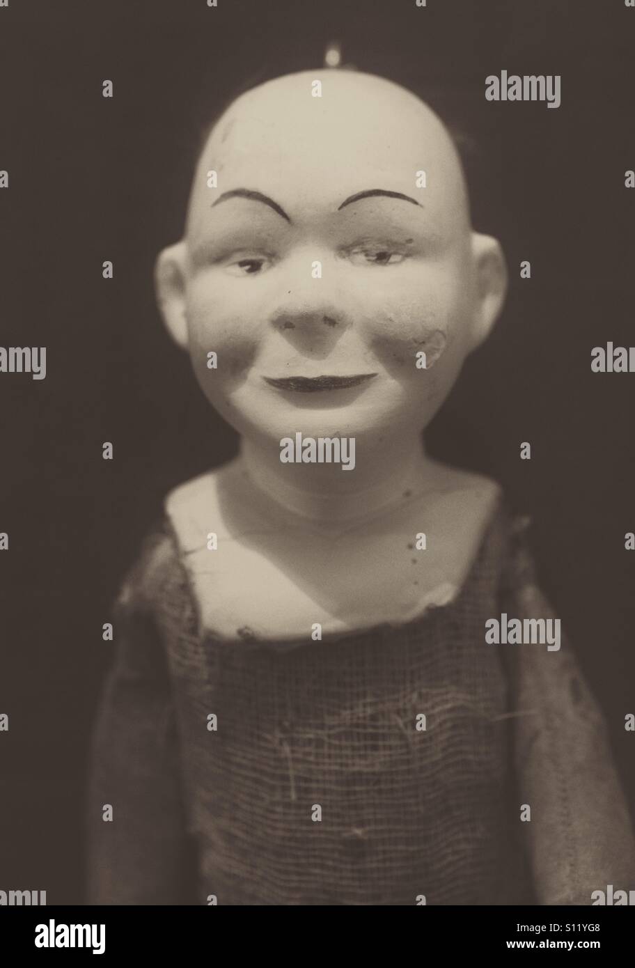 A scary, old doll with a bald head and rags for clothes. - Smartphone Captured Stock Image