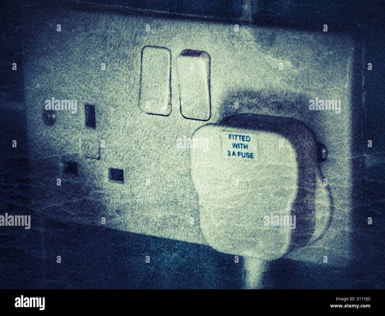 Plug in a double socket, switch on. - Smartphone Captured Stock Image