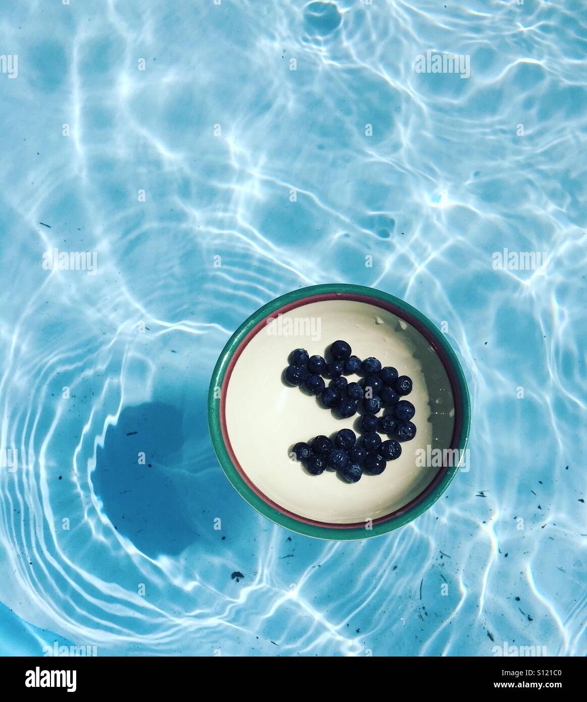 Blueberries floating in the pool. Summer in Ohio. Stock Photo