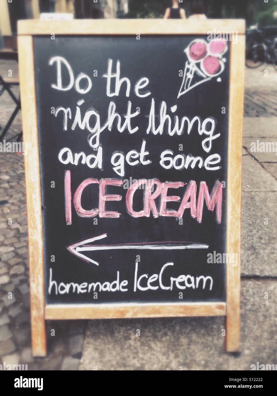 Sign in Berlin Kreuzberg saying do the right thing and get some ice cream, home made ice cream - Smartphone Captured Stock Image