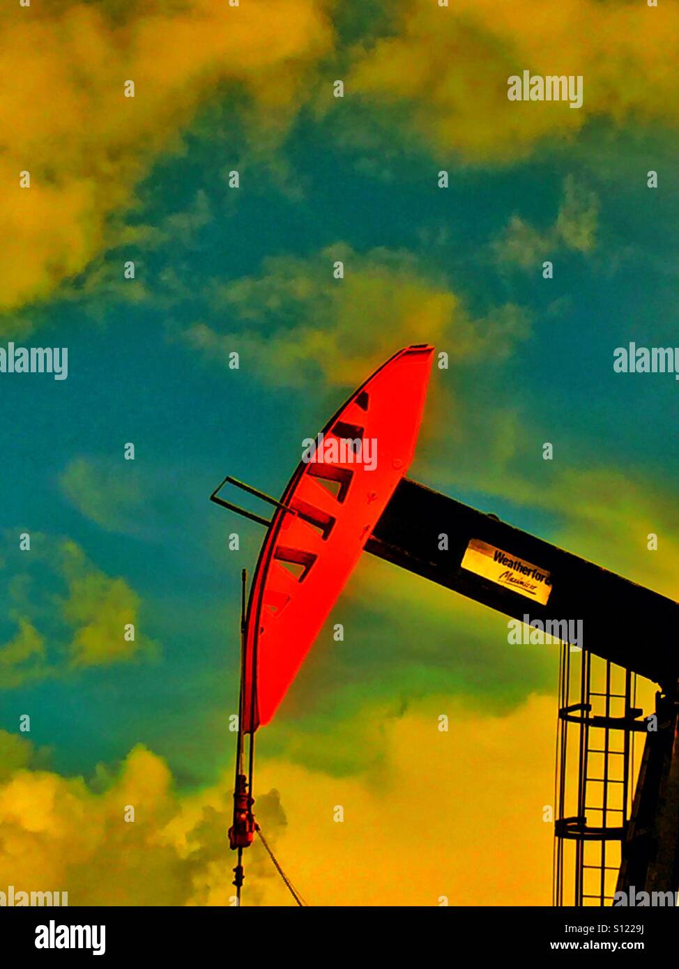 Red and black oil well pump jack head - Smartphone Captured Stock Image