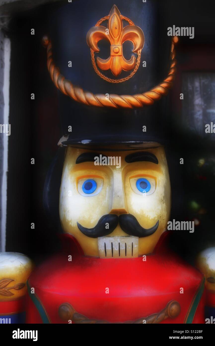 The head and shoulders of a toy soldier in a bright red uniform wearing a large black hat with a badge on. - Smartphone Captured Stock Image