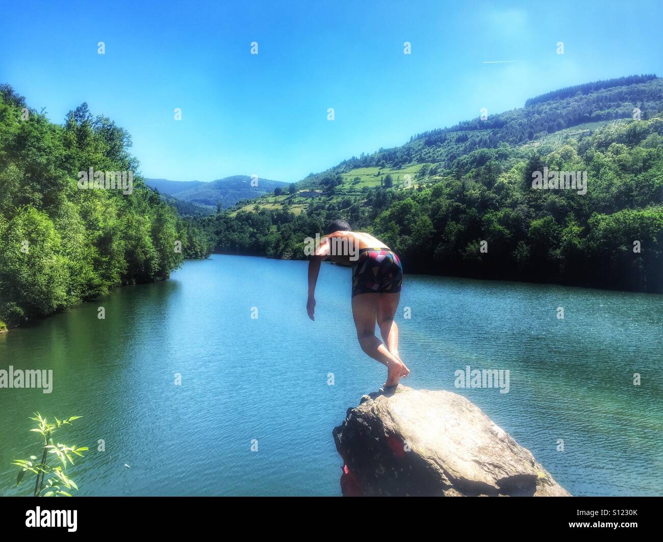 Man jumping in river Stock Photo Alamy