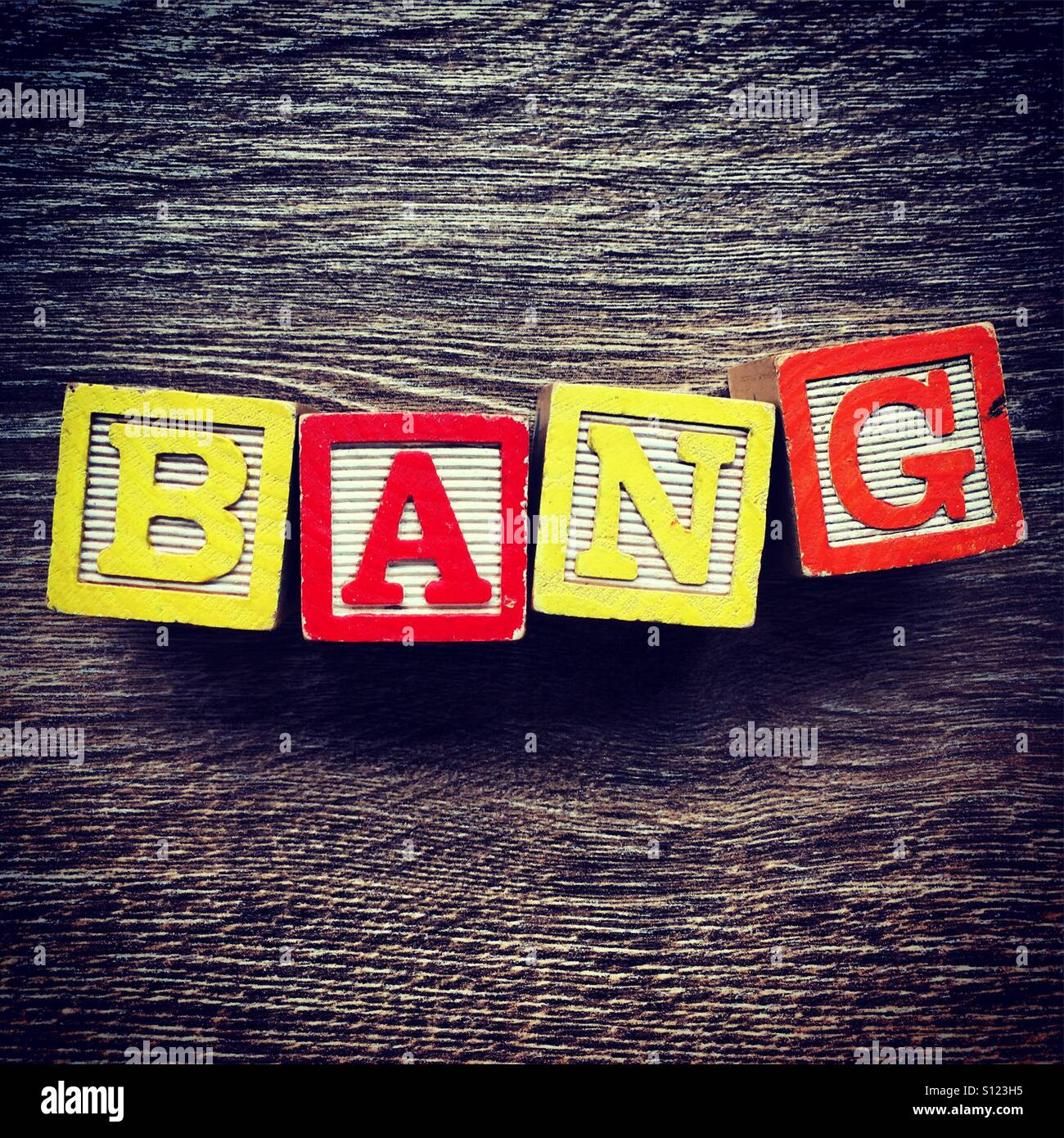 BANG word text done with wood blocks letters - Smartphone Captured Stock Image