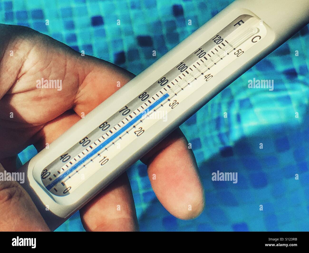 Reading a water thermometer in swimming pool, checking water temperature  Stock Photo - Alamy