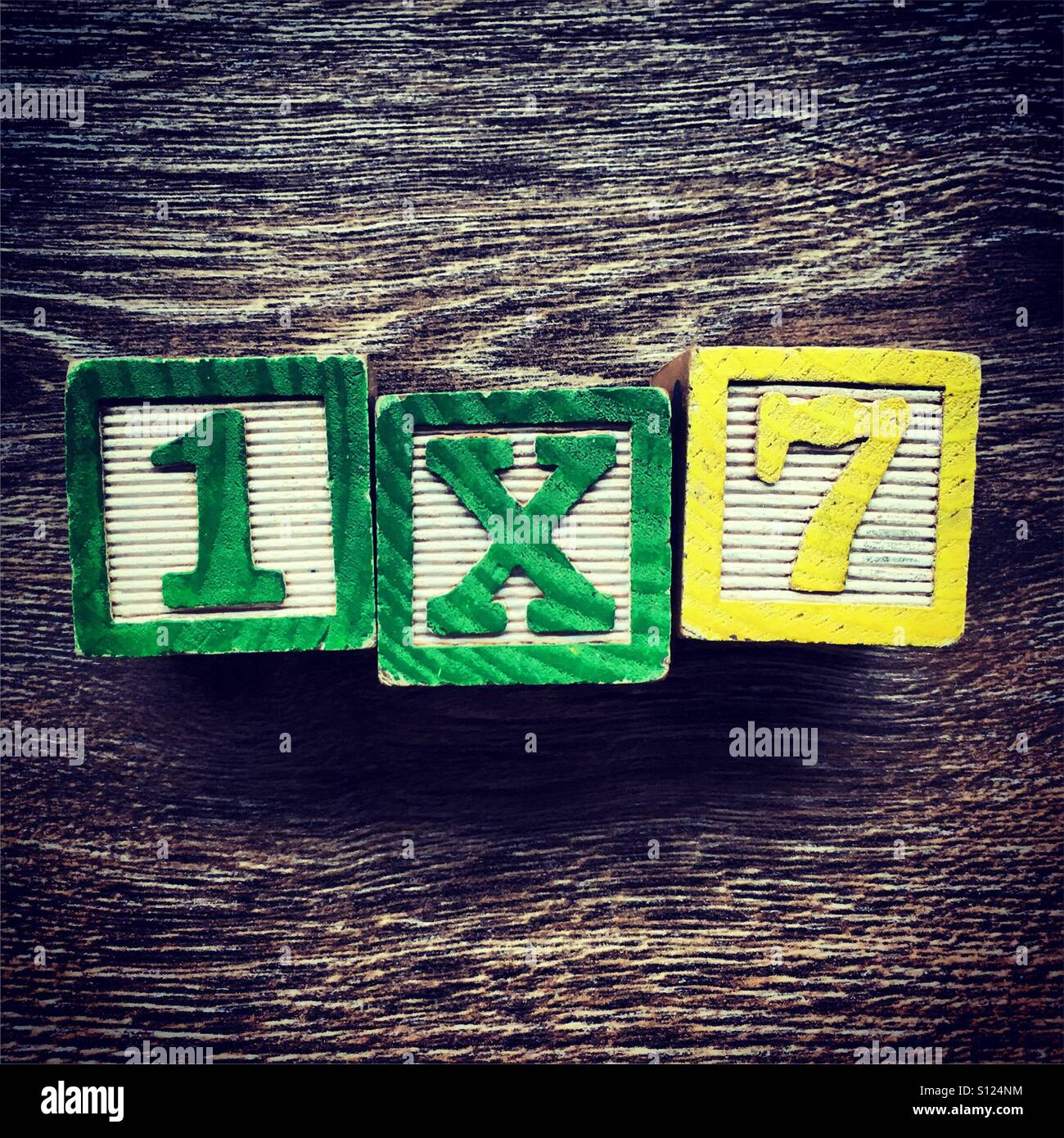 1x7 written with wood block number toys - Smartphone Captured Stock Image